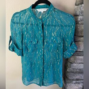 Trina Turk silk blend sheer button down top with gold accents and pockets.